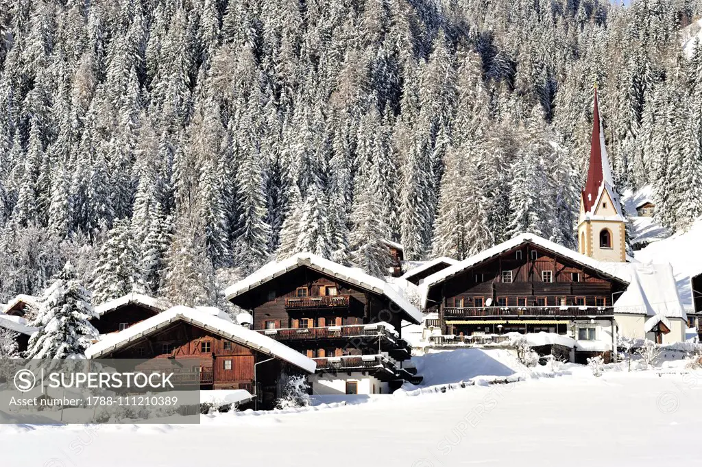 View of St Nikolaus under the snow, with St Nicholas church in the centre, 14th century, Ultental valley, Trentino-Alto Adige, Italy.