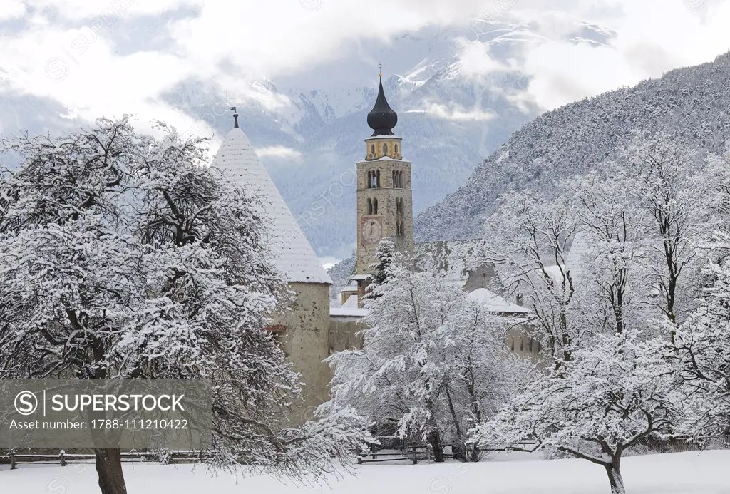 View of Glurns and bell tower of Saint Pankraz Church, snowy landscape, Upper Vinschgau Valley, Trentino-Alto Adige, Italy.