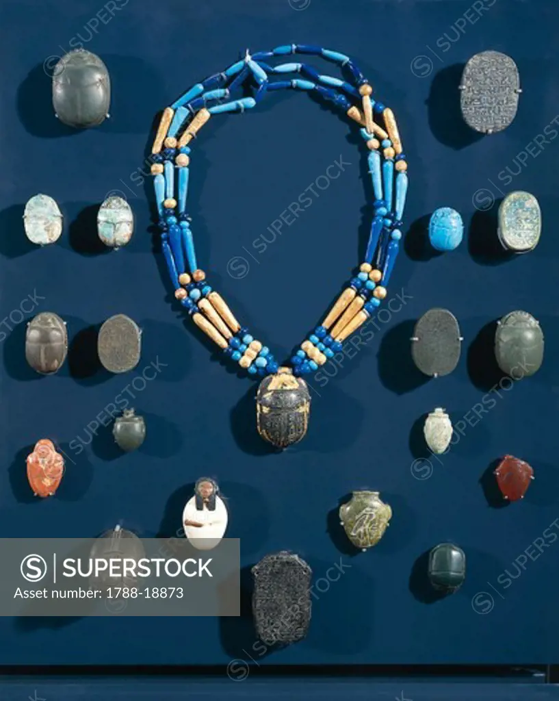 Ancient Egyptian ornaments and protective objects of the mummy: necklace and scarabs