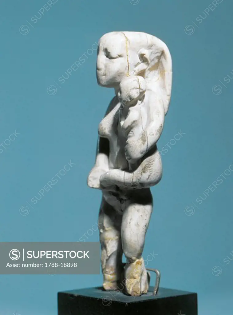 Ancient Egyptian ivory statuette of woman holding child in arms, Predynastic Period, 3100-3000 B.C.