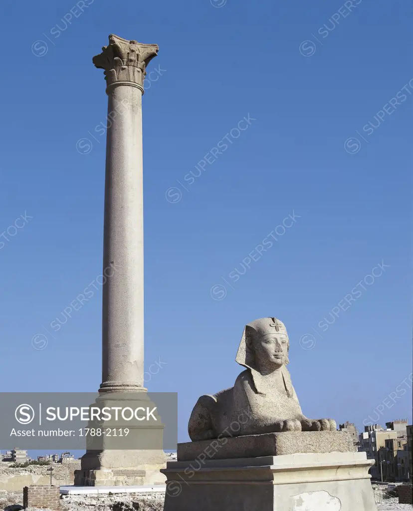 Egypt - Alexandria. Ptolemaic Serapeum. Pompey's Pillar and granite sphinx