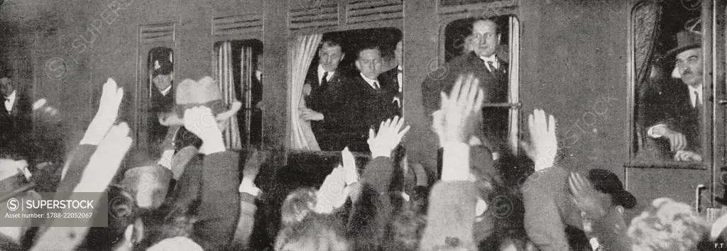 Italians waving and cheering Benito Mussolini as his train passes through Paris station on his journey to the London Conference, France, from L'Illustrazione Italiana, Year XLIX, No 51, December 17, 1922.