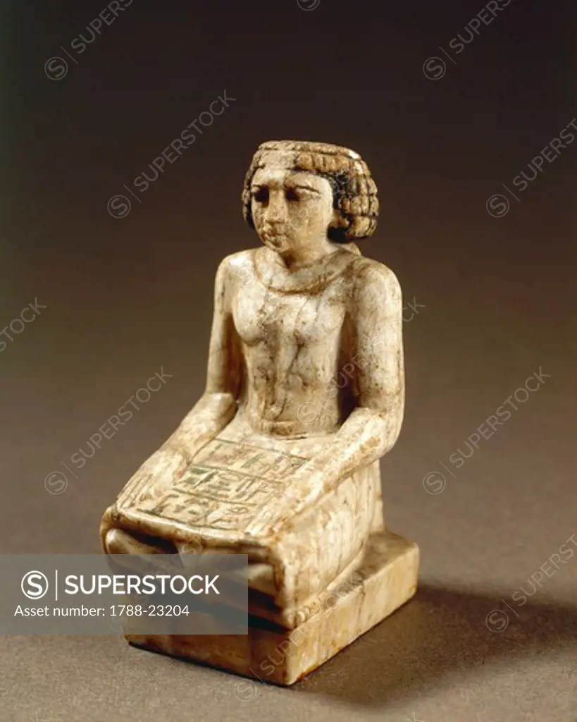 Statuette representing a scribe sitting cross-legged on the floor with hands on thighs and a papyrus scroll opened on the skirt