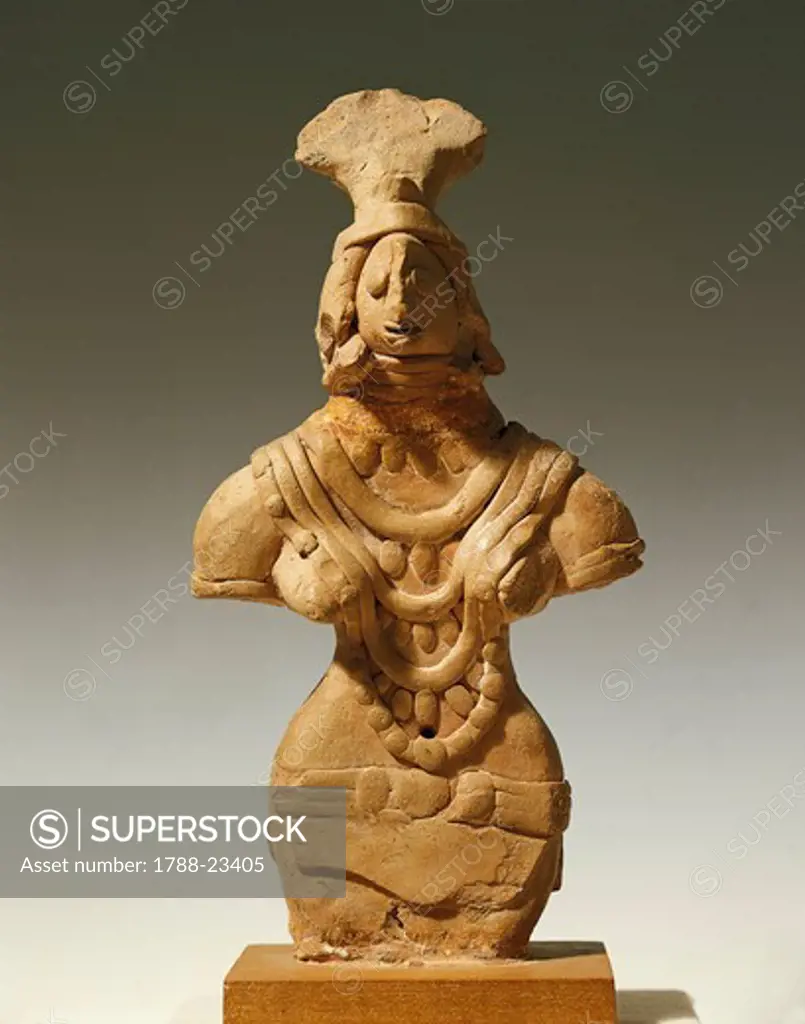 Woman with jewels and a fan shaped hat, late Mohenjo-daro period, terracotta statuette