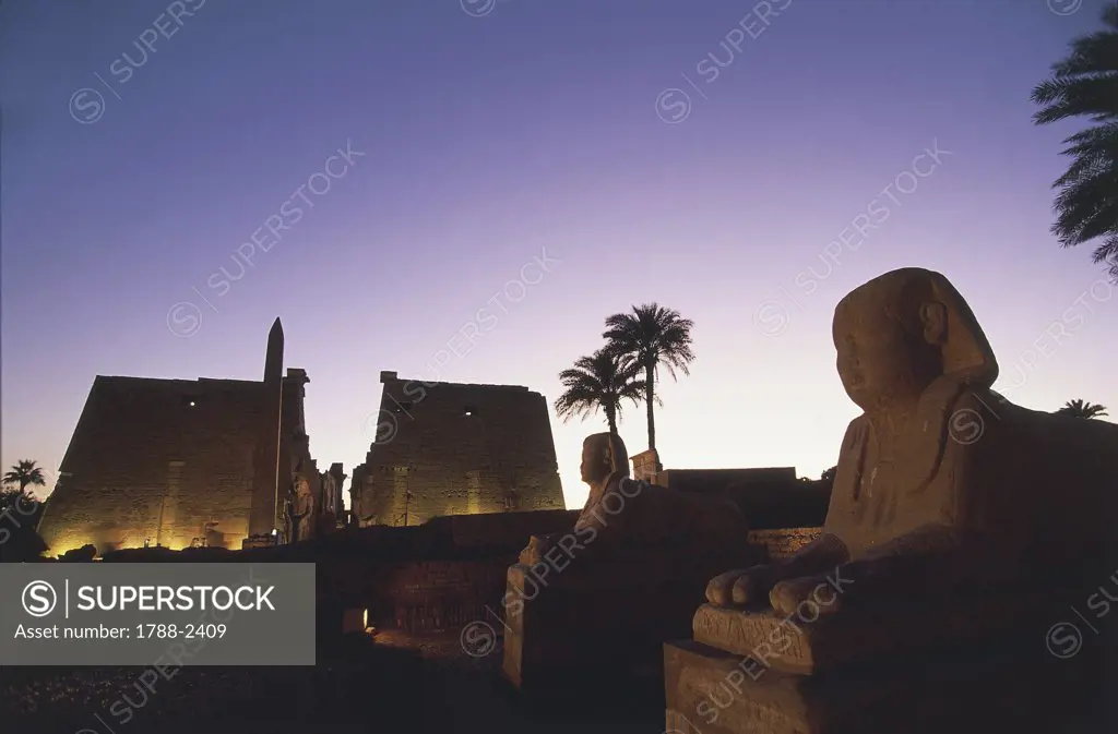 Africa - Egypt - Luxor. Ancient Egyptian temple complex and monumental sphinxes. Night view. UNESCO World Heritage List, 1979