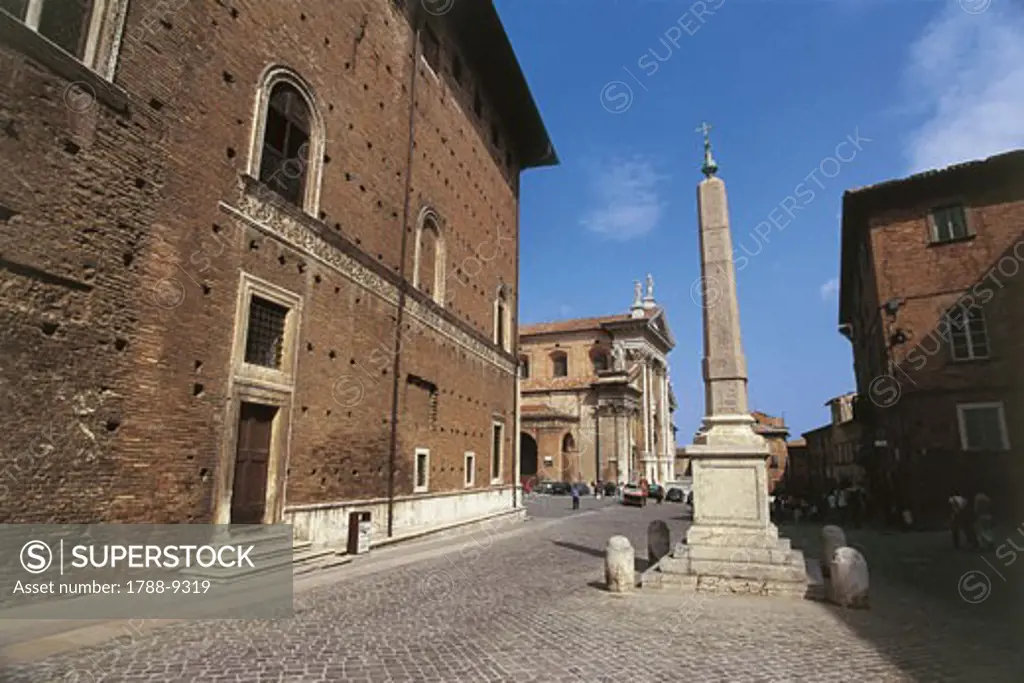 Low angle view of an obelisk in front of a cathedral, Risorgimento Square, Urbino, Marches, Italy