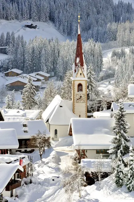 View of St Nikolaus covered in snow, with St Nicholas church in the centre, 14th century, Ultental valley, Trentino-Alto Adige, Italy.