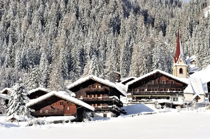 View of St Nikolaus under the snow, with St Nicholas church in the centre, 14th century, Ultental valley, Trentino-Alto Adige, Italy.