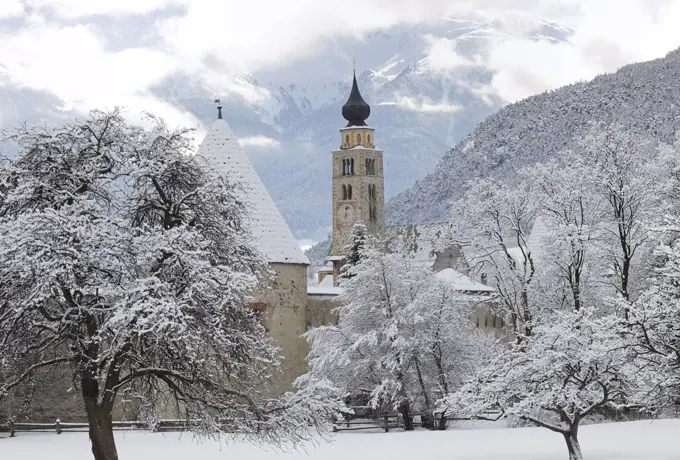 View of Glurns and bell tower of Saint Pankraz Church, snowy landscape, Upper Vinschgau Valley, Trentino-Alto Adige, Italy.