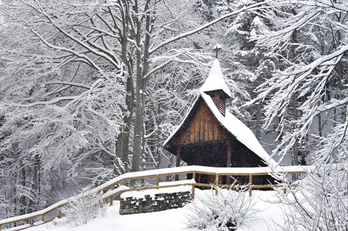 Wooden church in the military cemetery for the soldiers fallen during World War I, in the snow, in Slaghenaufi, Lavarone, Trentino-Alto Adige, Italy.