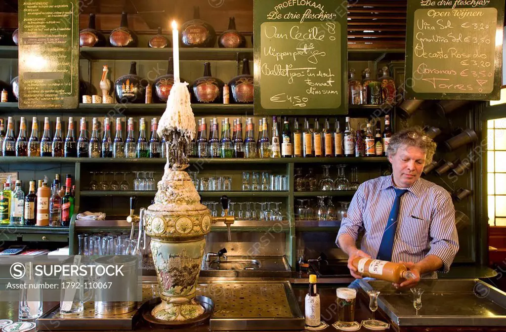 Netherlands, Northern Holland Province, Amsterdam, Proeflokaal Cafe, De Drie Fleschjes, the owner is serving genievre alcohol dutch gin