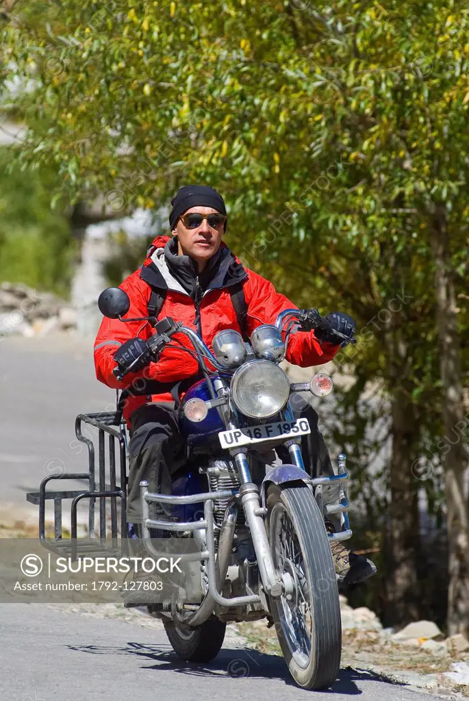 India, Jammu and Kashmir State, Ladakh Region, Himalayan foothills, Royal Enfield 500 cc motorbiker arriving at Hemis village