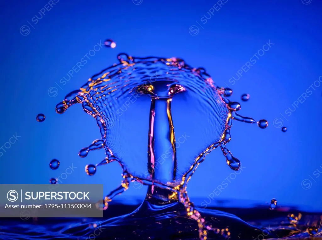 Splashing water against blue background