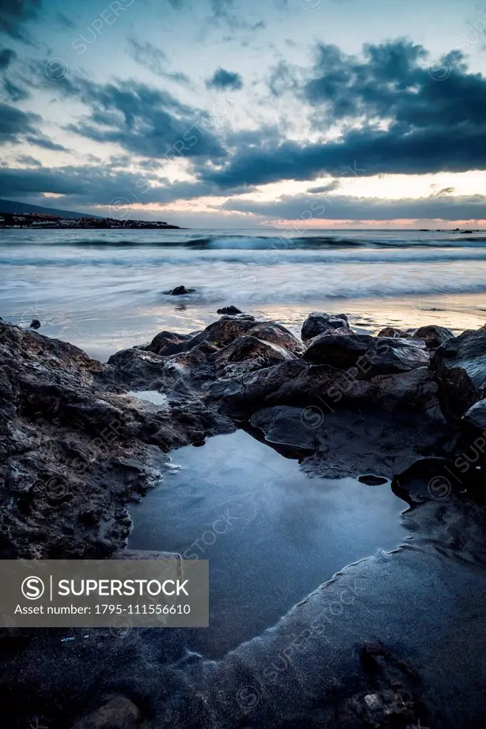 Rocks on beach at sunset in Tenerife, Spain