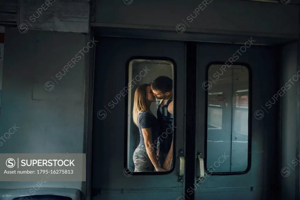 Couple kissing on train