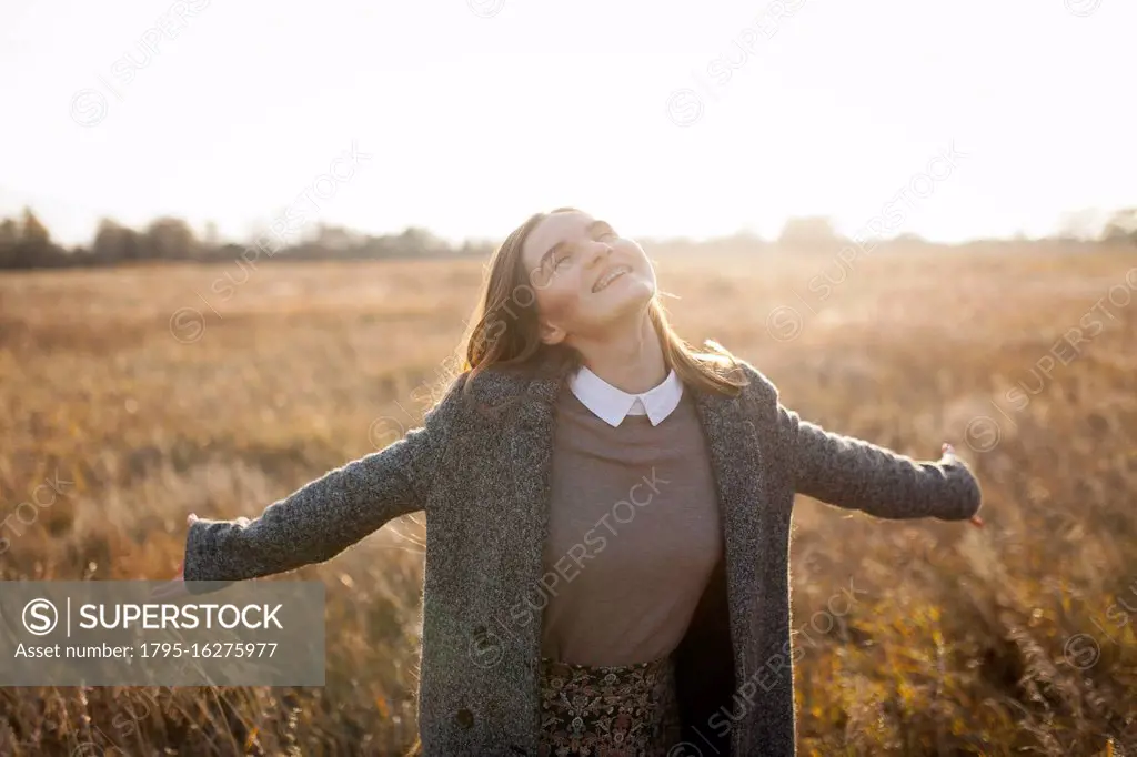 Russia, Omsk, Portrait of young woman in field