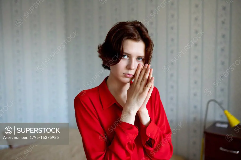 Portrait of young woman at home