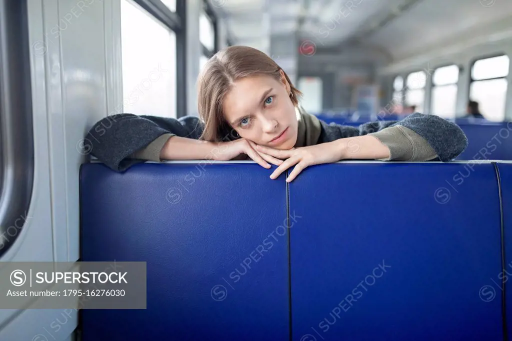 Portrait of young woman in train