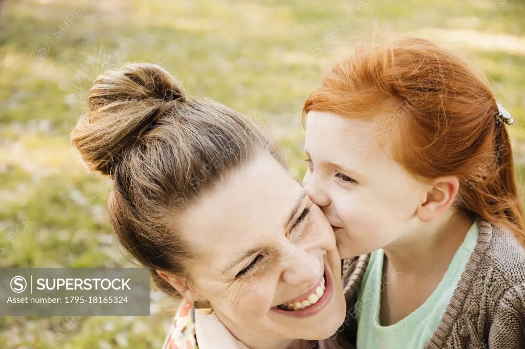 Portrait of smiling mid adult mother and daughter in park