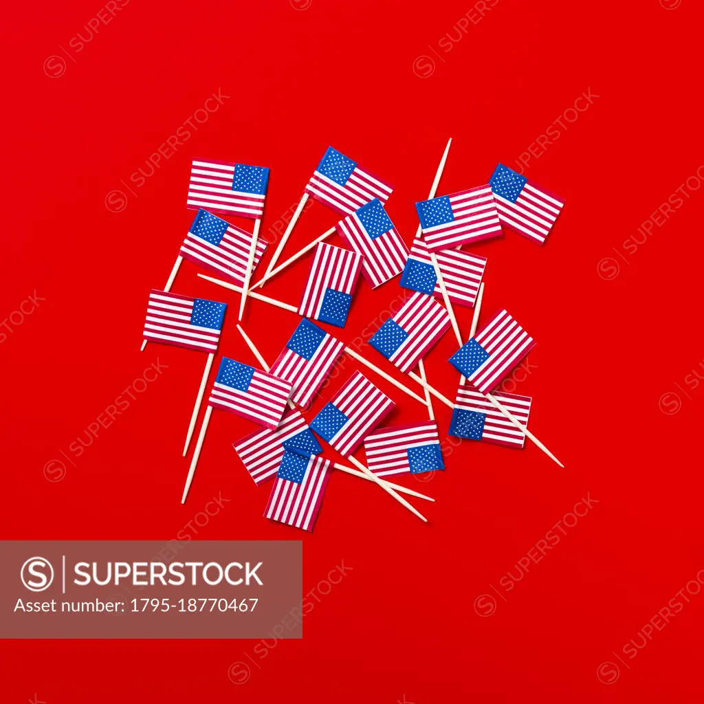 Small American flag toothpicks on red background