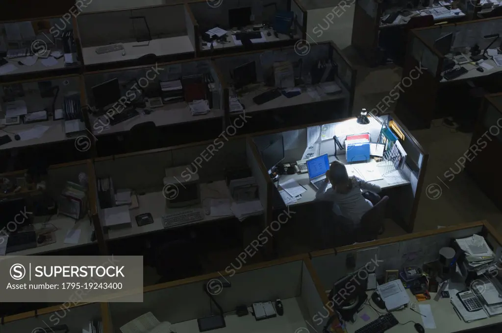 Woman working late at night in office