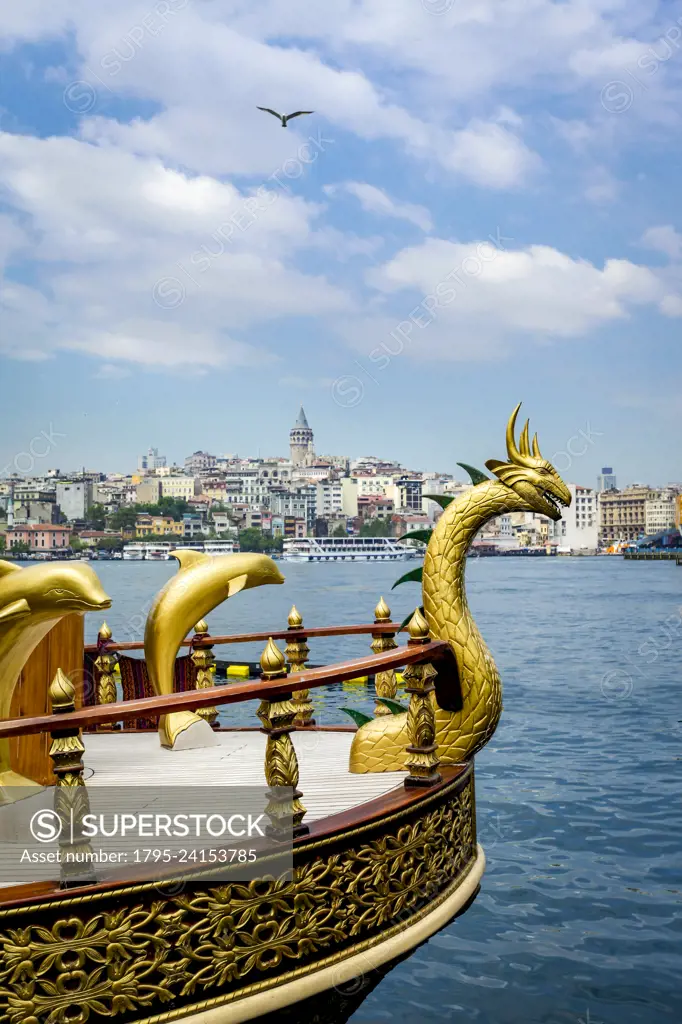 Turkey, Istanbul, Gold serpent and dolphins on bow of ship on Bosphorus