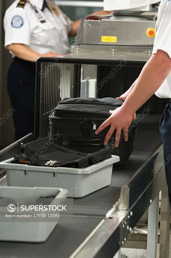 Airport security worker checking baggage