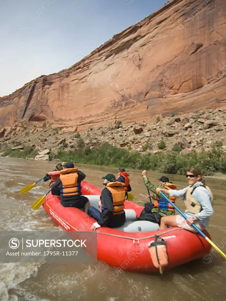 Group of people river rafting