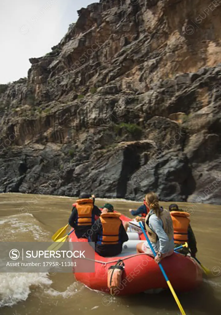 Group of people river rafting