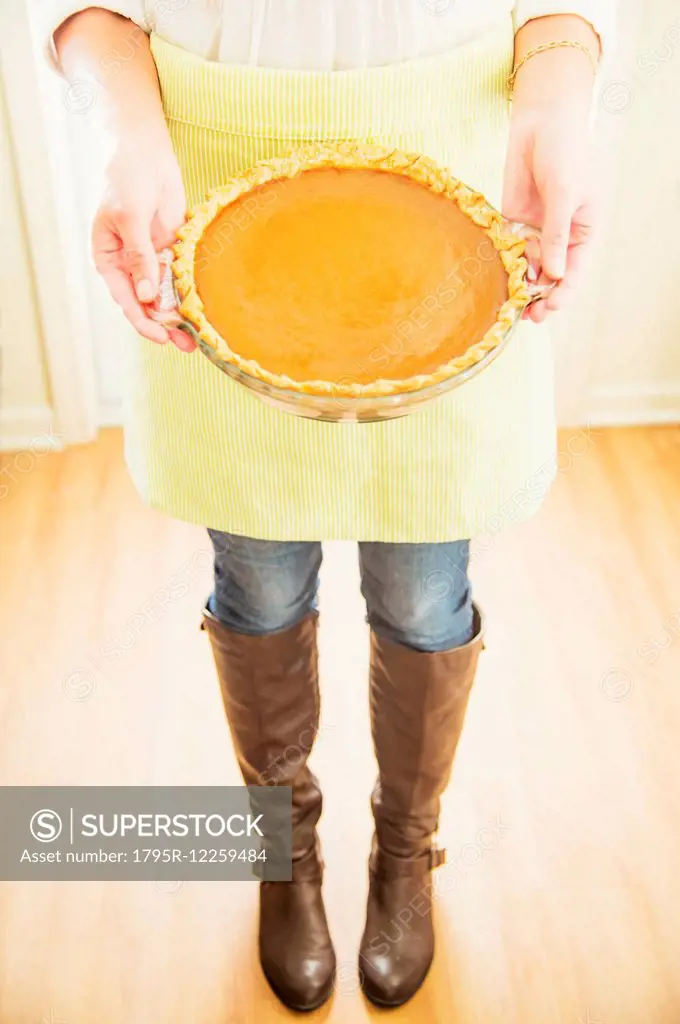 Woman holding pumpkin pie