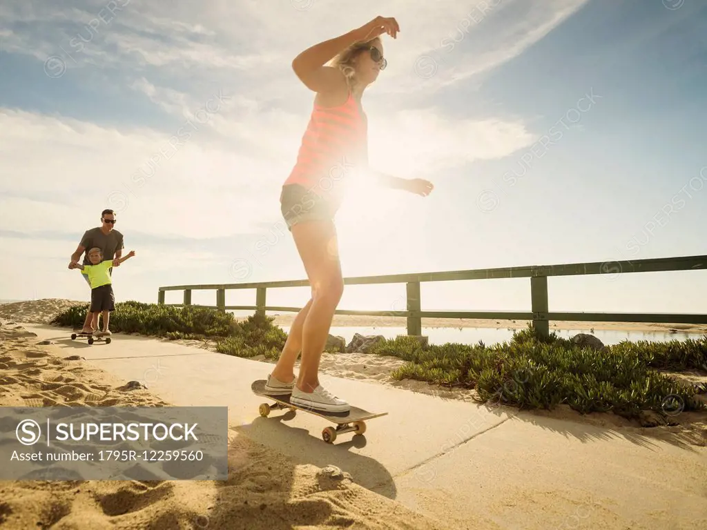 Parents skateboarding with their son (6-7)