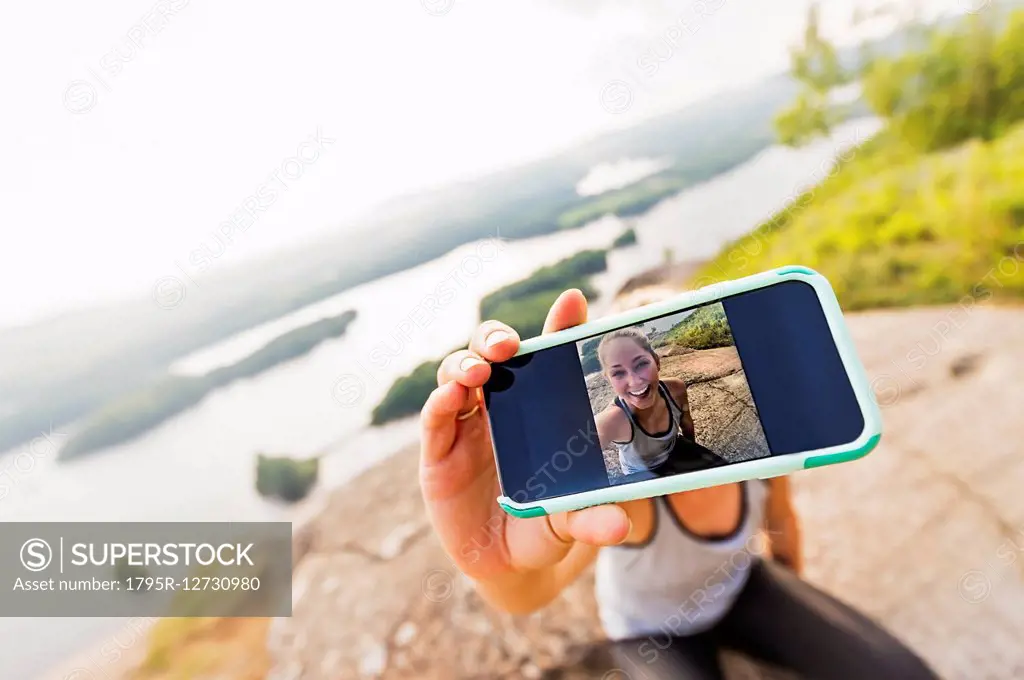 Young woman taking selfie on Smartphone