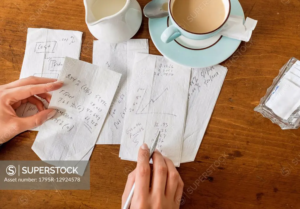 Woman writing on napkins