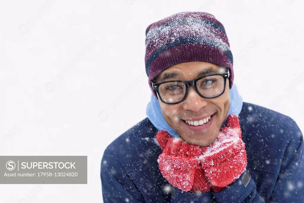 Portrait of mid adult man standing on snow