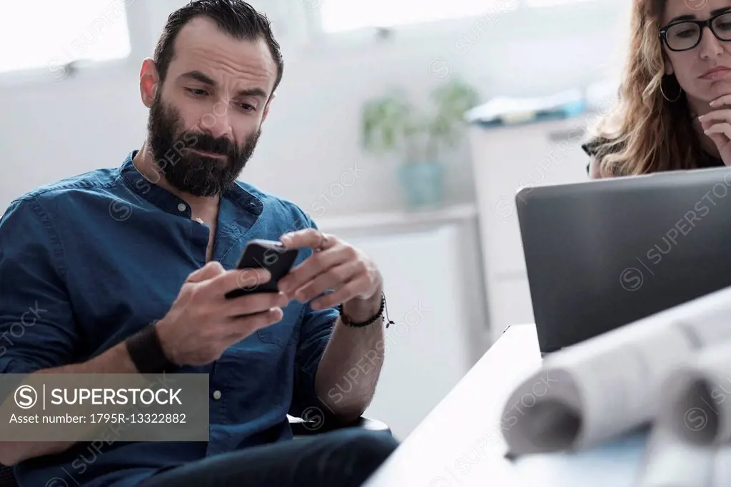 Man and woman working in office