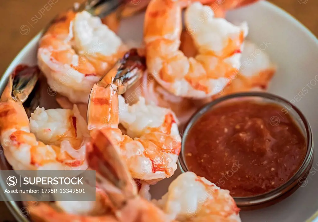 Shrimps and cocktail sauce in bowl