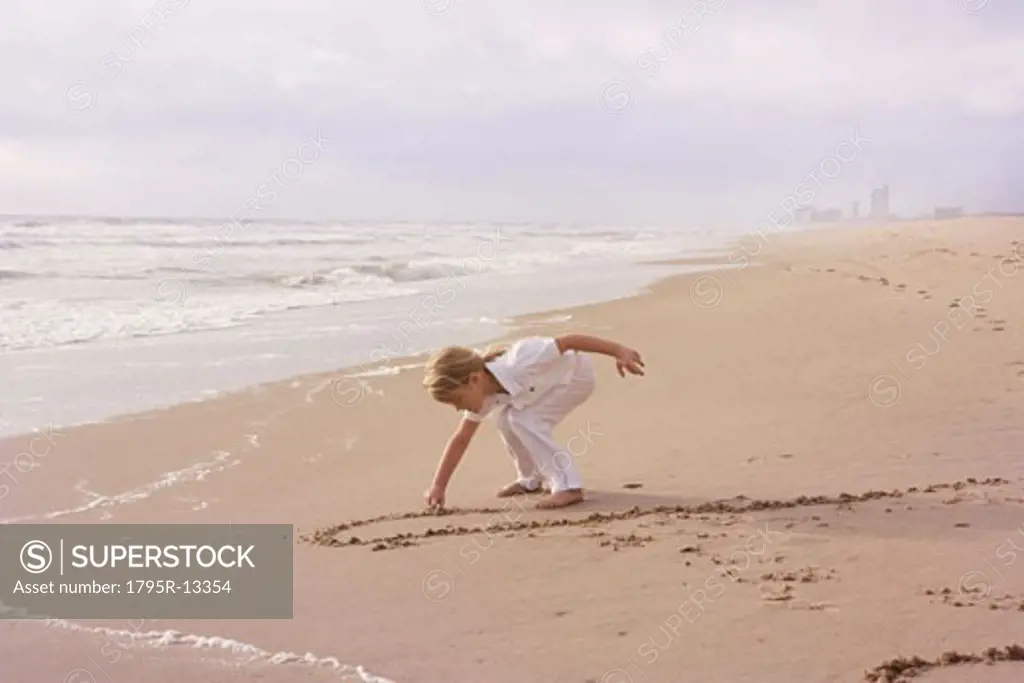 Girl drawing in sand