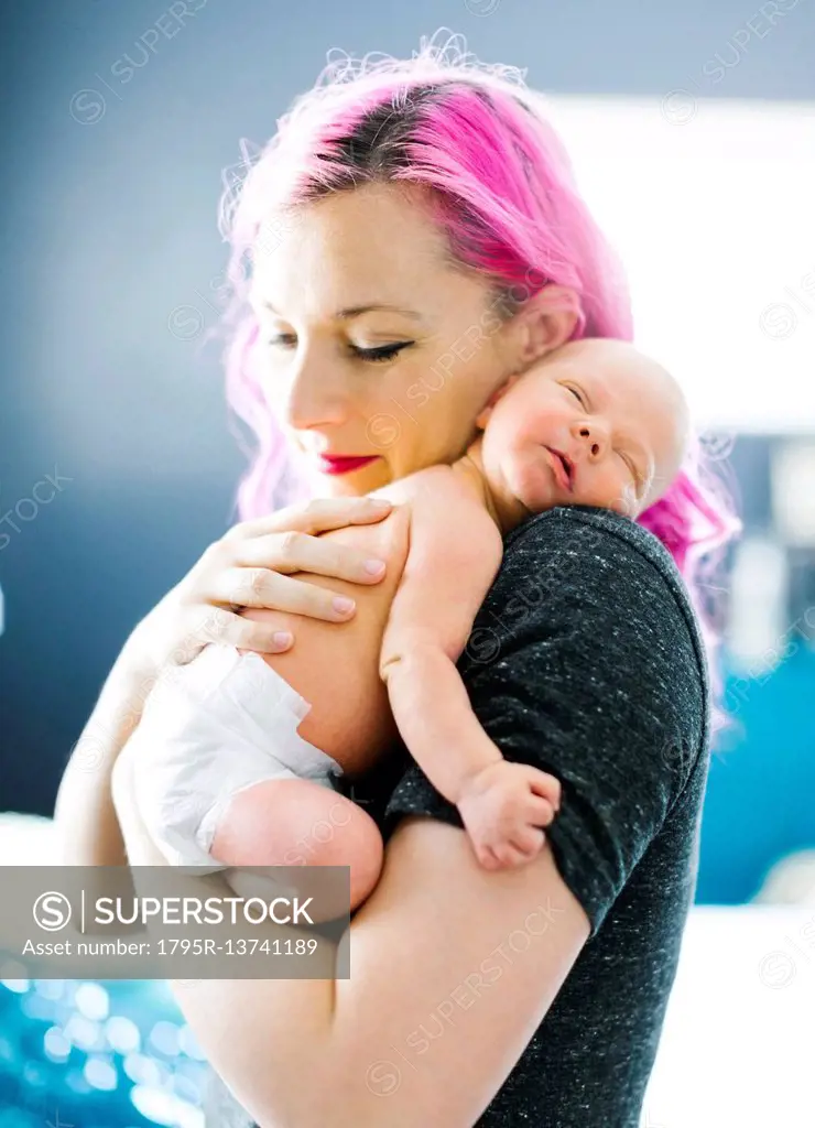 Mother embracing newborn son (2-5 months)