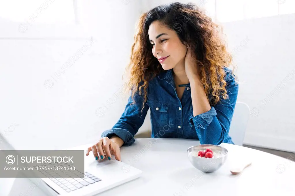 Woman using laptop at table