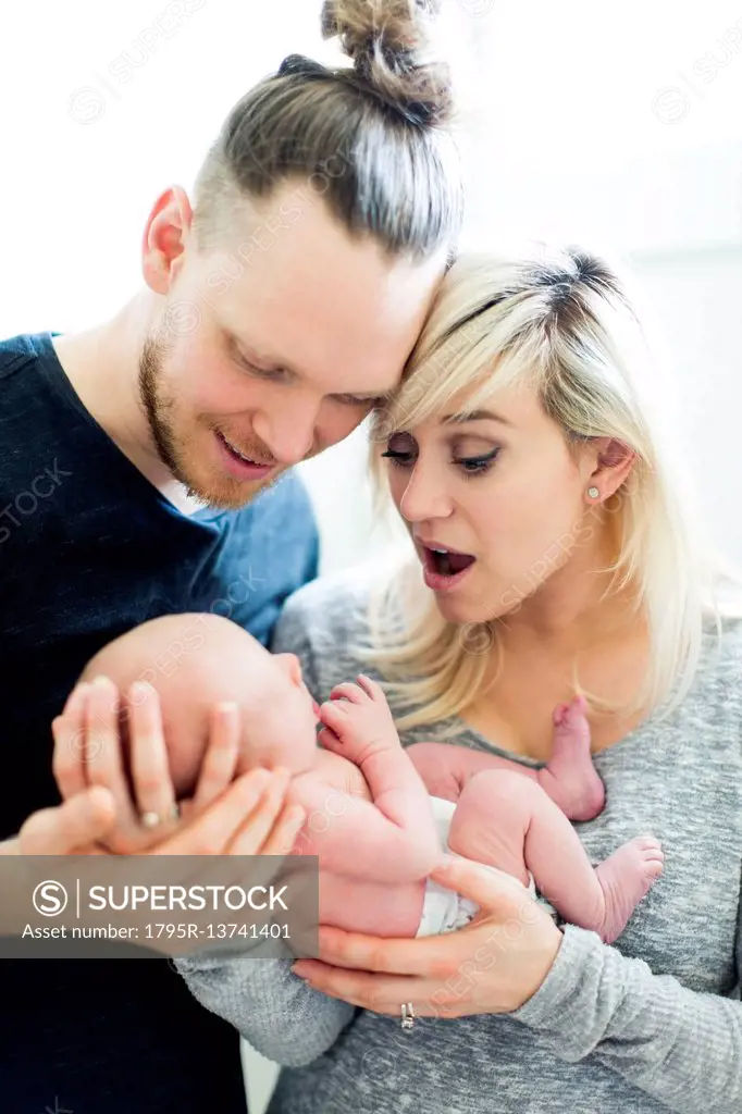 Parents holding newborn (0-1 months)