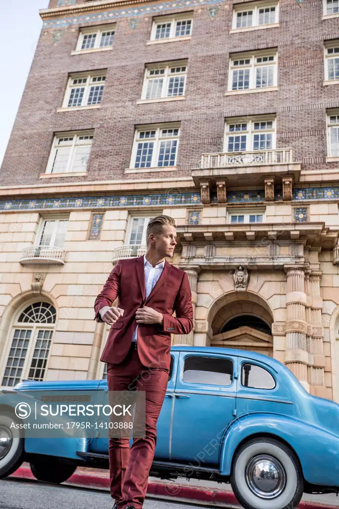 USA, Utah, Salt Lake city, Elegant man crossing street, vintage car in background