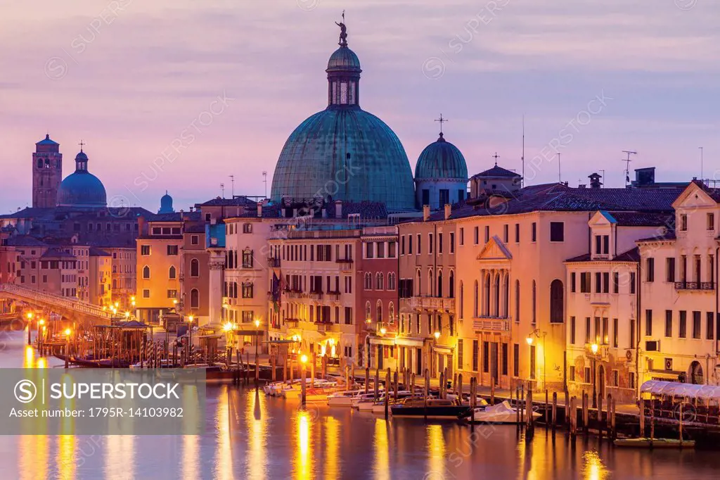 Italy, Veneto, Venice, Street light reflecting in water with Dome of Santa Maria della Salute Basilica