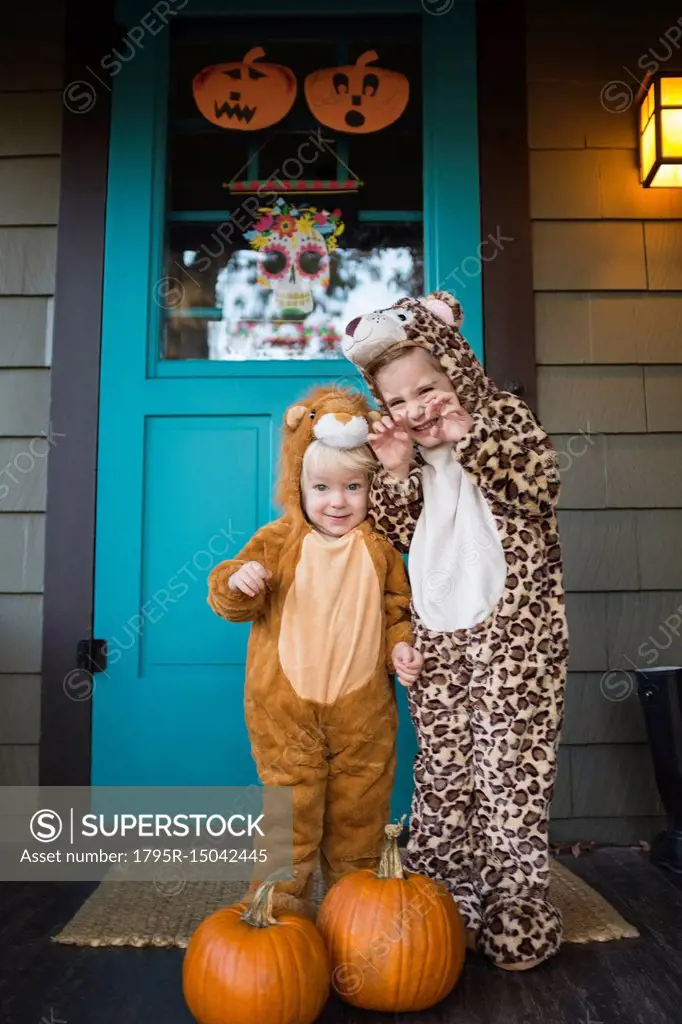 Two kids (2-3, 4-5) wearing Halloween costumes