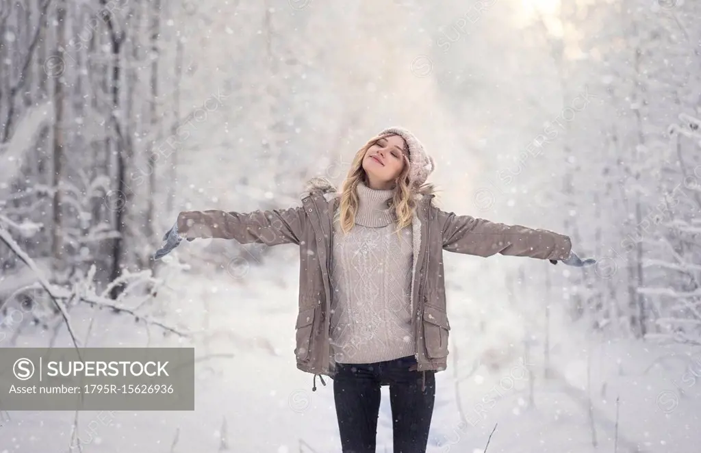 Young woman in forest during winter