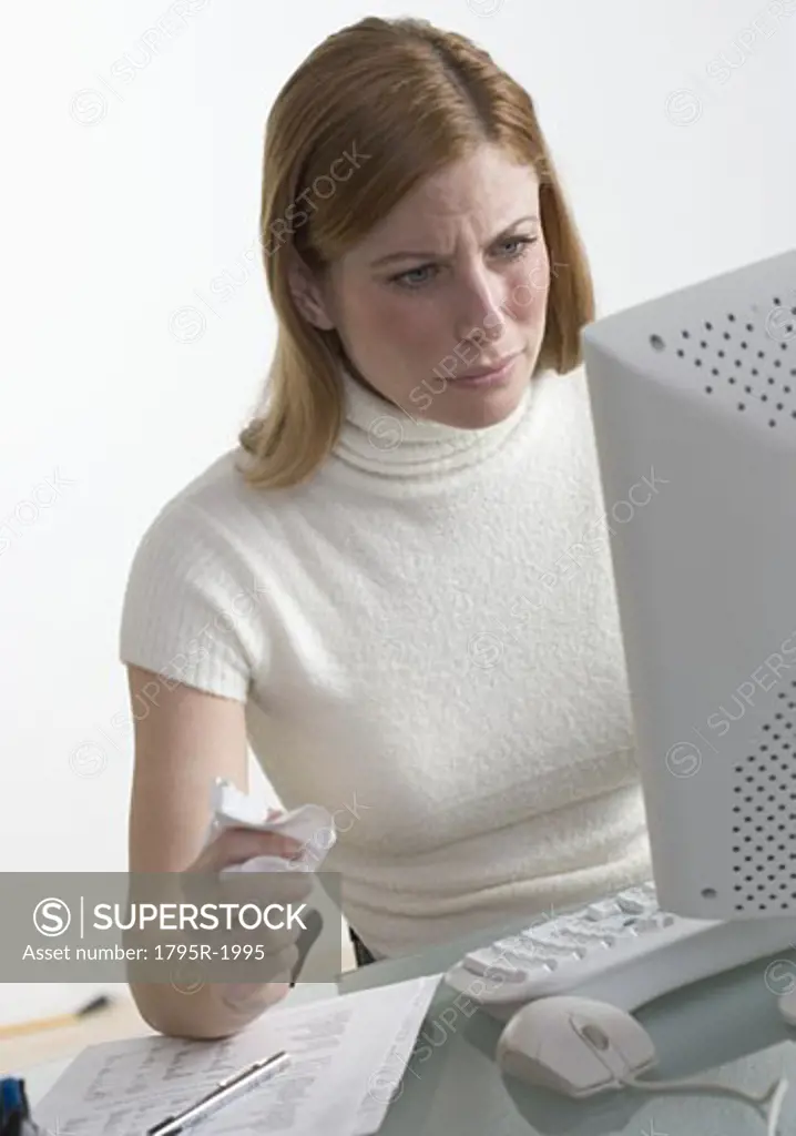 Distressed woman at desk with computer