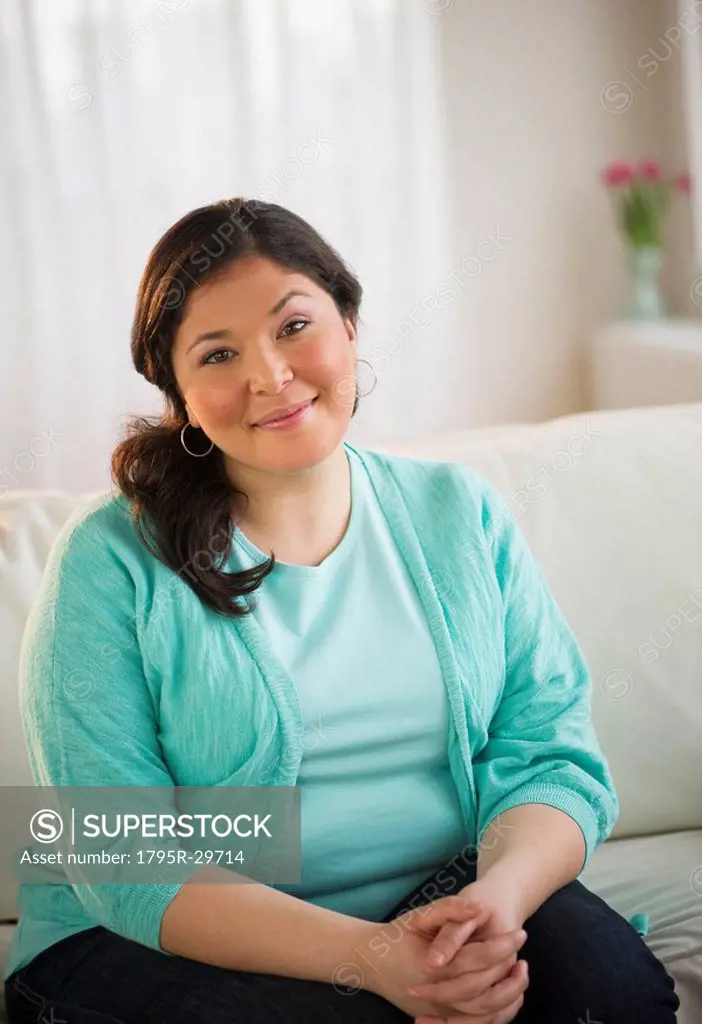 Overweight woman sitting on couch