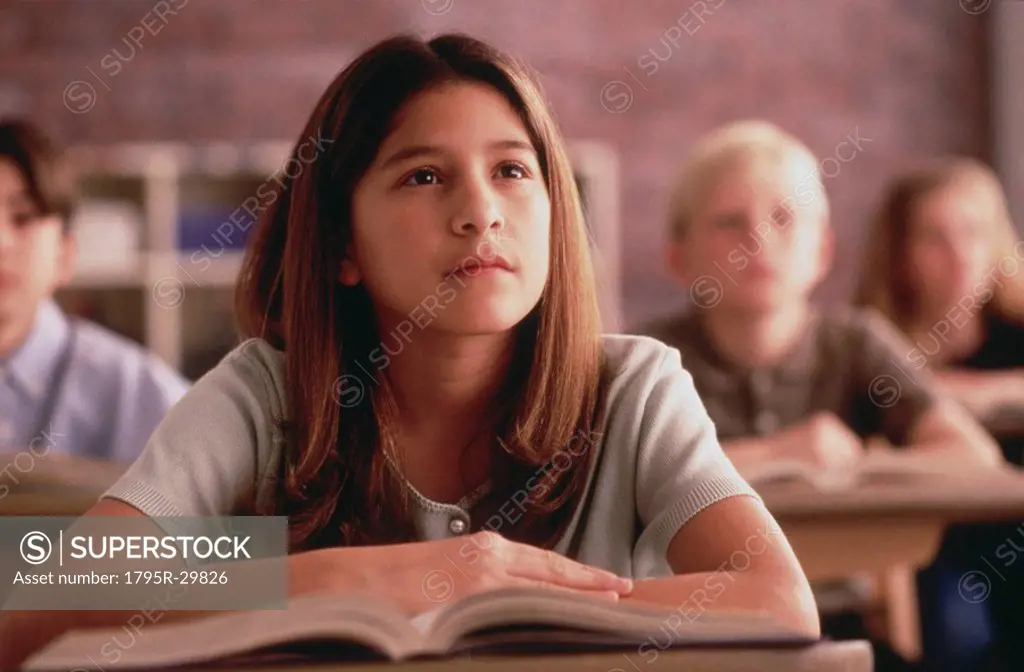 Elementary school students listening to their teacher