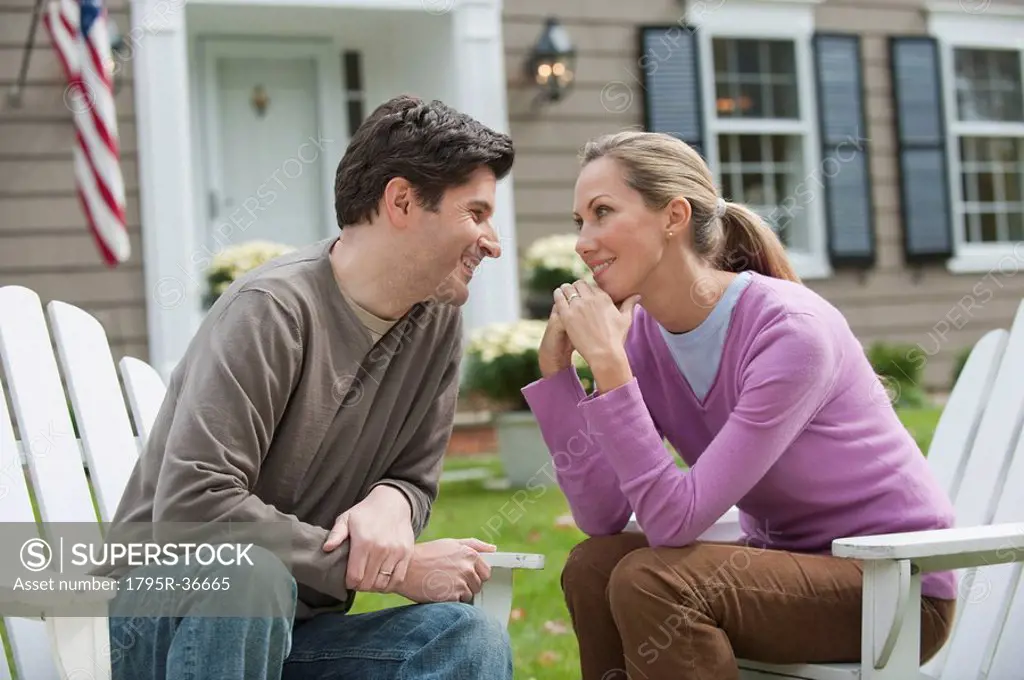 Couple in front of house