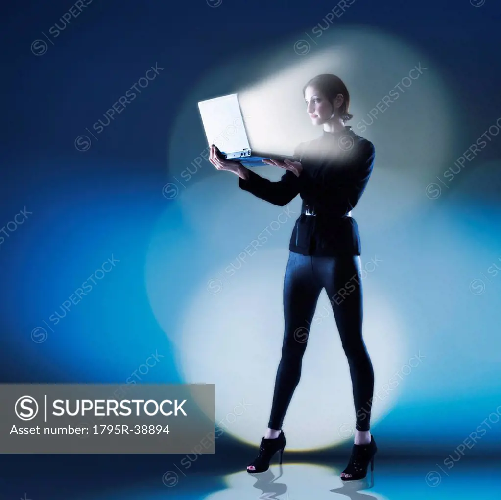 Young woman using laptop with bright light