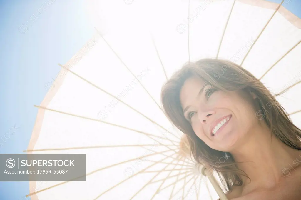 Woman in sunlight with parasol